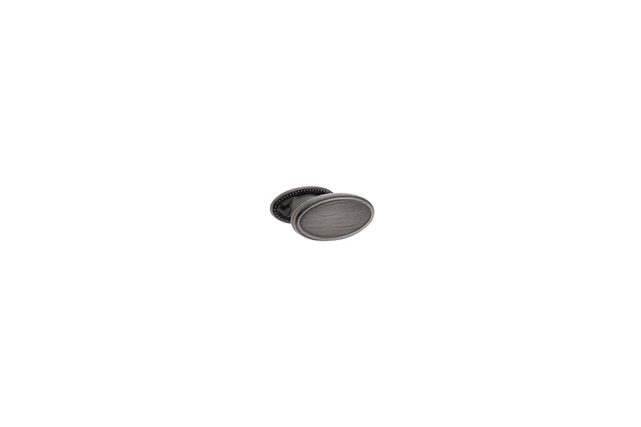 Buton mobilier Tulip Tomo – cositor antichizat (old tin), oval, 38 × 19 mm, cu șurub